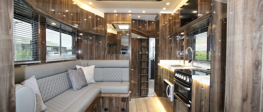 living and kitchen area with stylish wood panelling in the 10 tonne horsebox