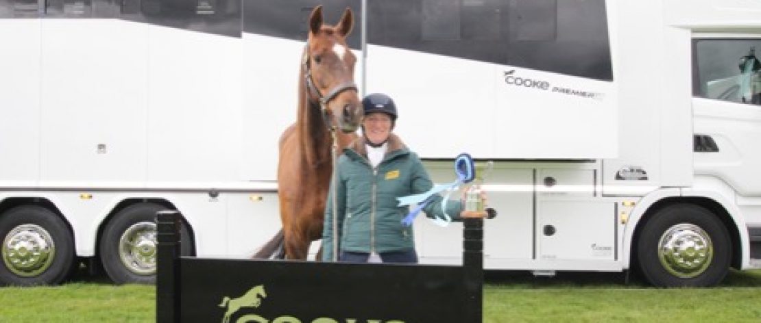 Photo of girl and a horse in front of cookes sign and 12 tonne horsebox